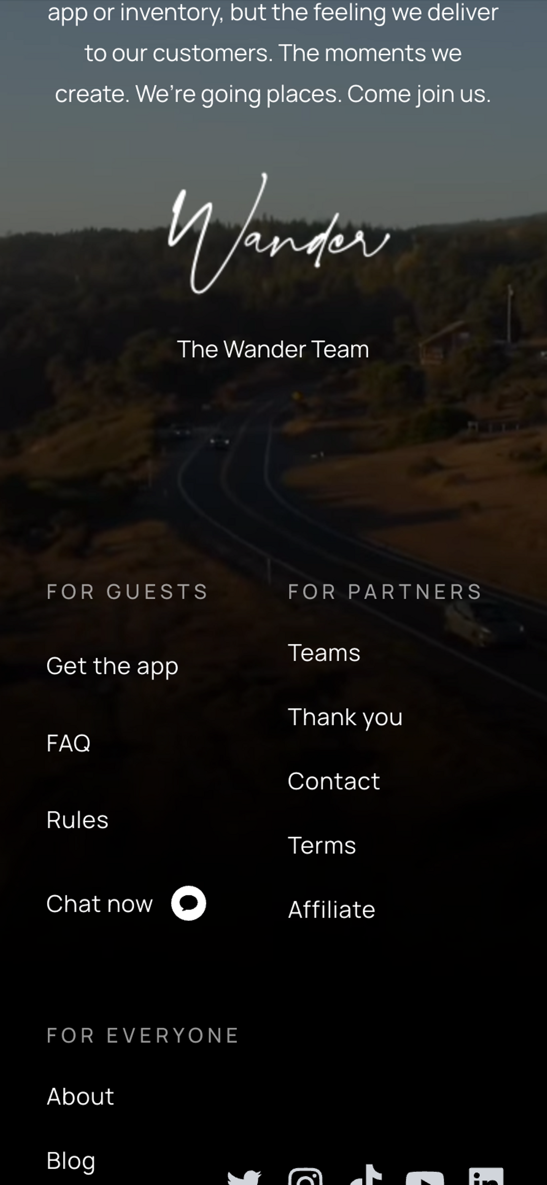 The footer of the Wander homepage on a mobile device. Above the footer is a message from the Wander team that ends with a handwritten signature saying 'Wander.'